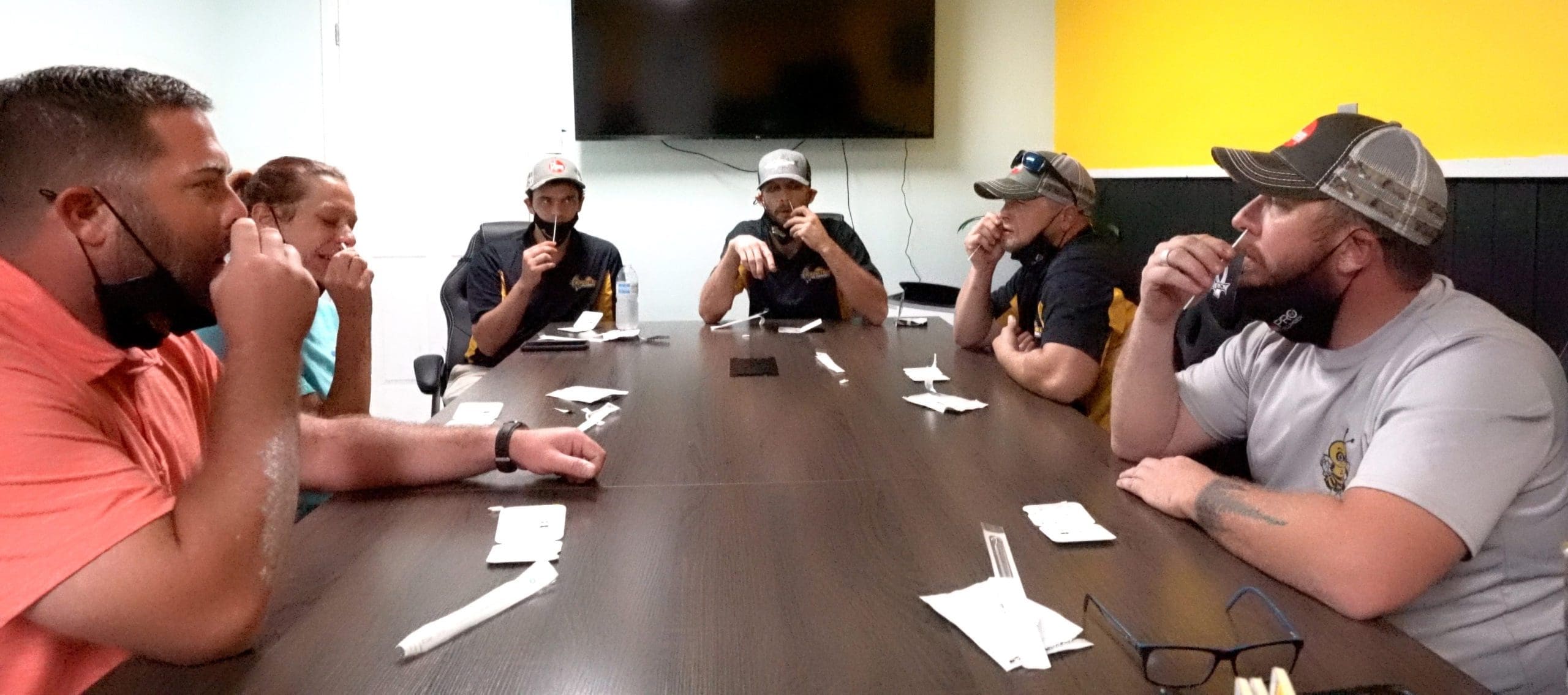 Honey Bee Plumbing team members swabbing their noses for COVID-19 testing