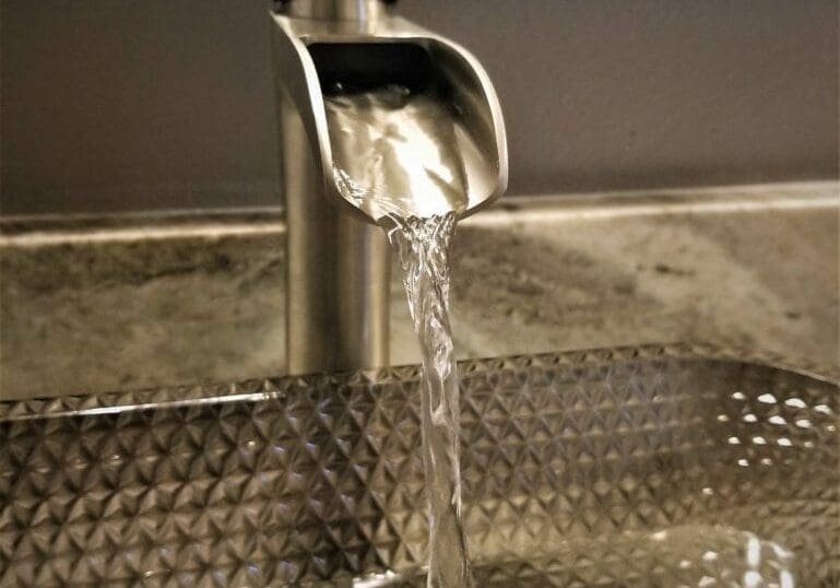 Image of a lavatory faucet running into a vessel sink in a Crestview, Florida home.