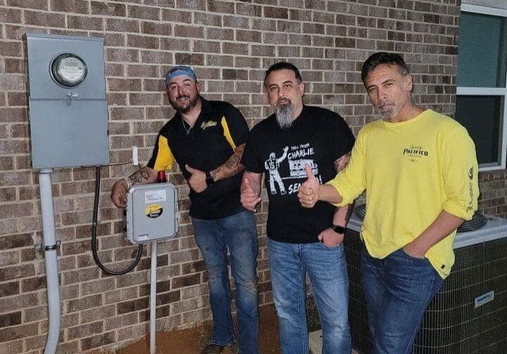 Happy Customers with New Sewage Lift Station Installation-171-tsh167 Expert plumber Jason Bailey with satisfied clients near a lift station control panel